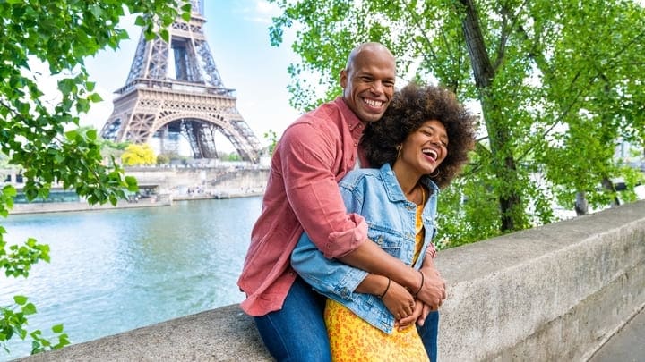 Happy couple in front of the Eiffel Tower