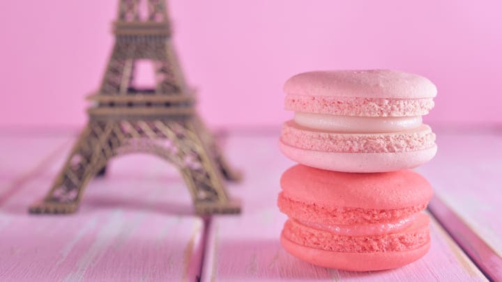 Eiffel Tower model next to some macarons