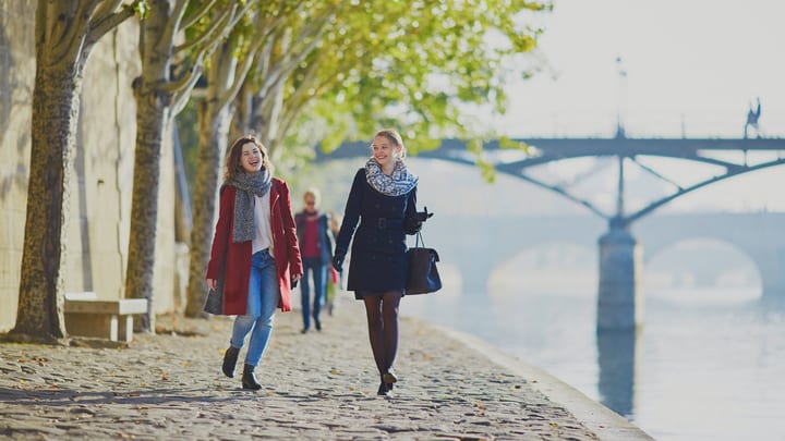Women strolling the riverside in Paris